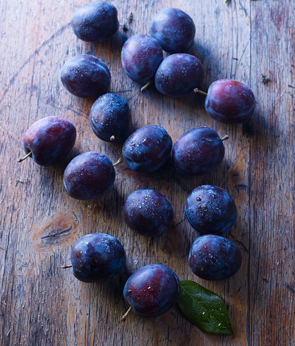 Plums on a rustic wooden surface