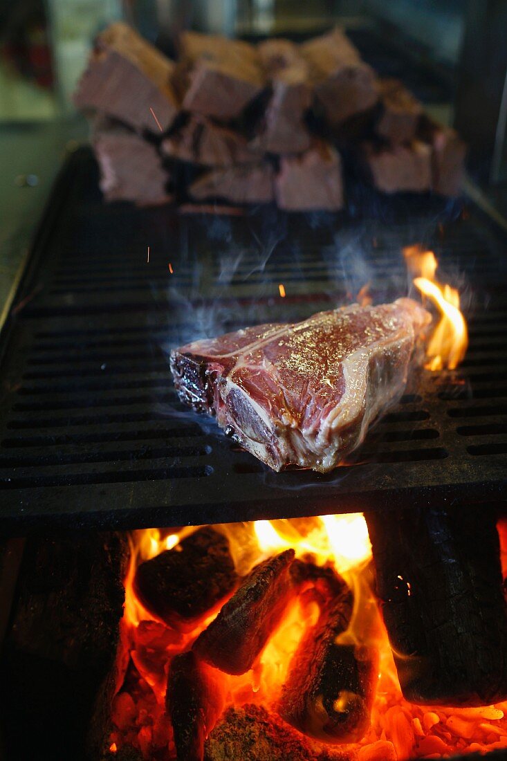 A T-bone steak on a barbecue