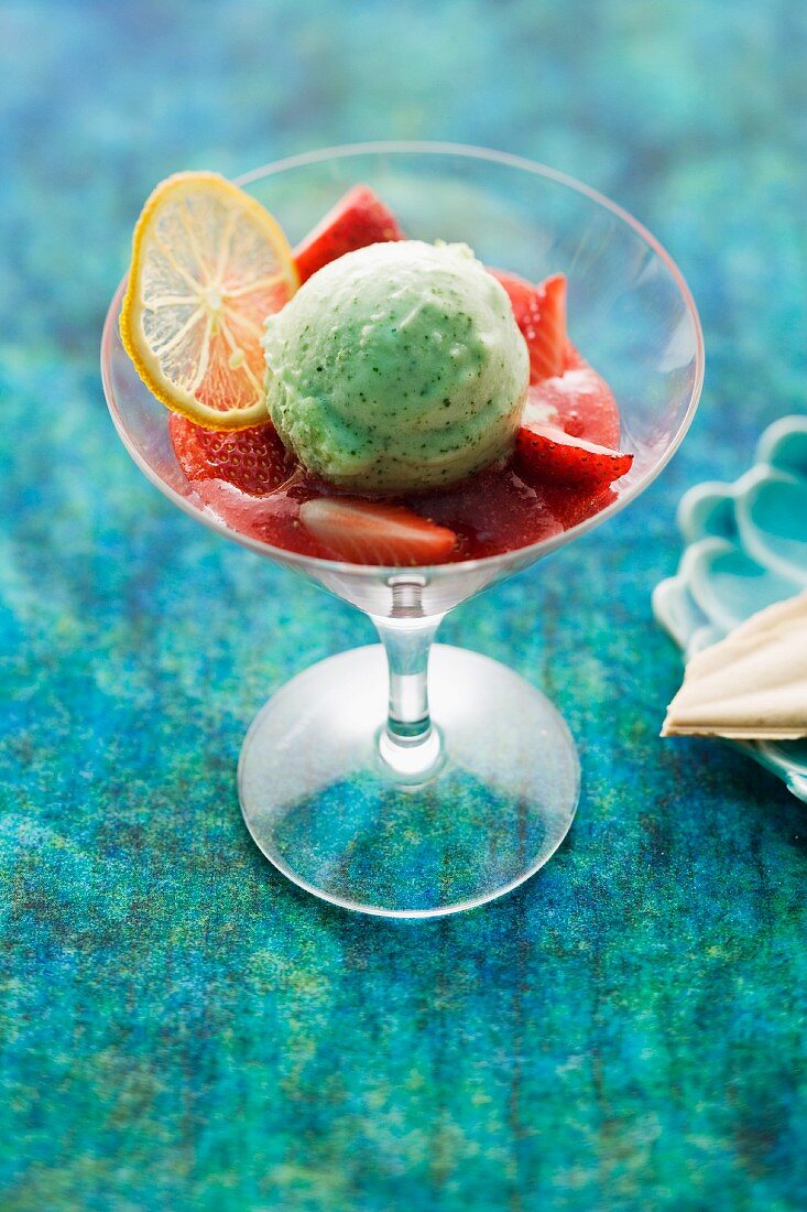 Lemon and basil ice cream on strawberries