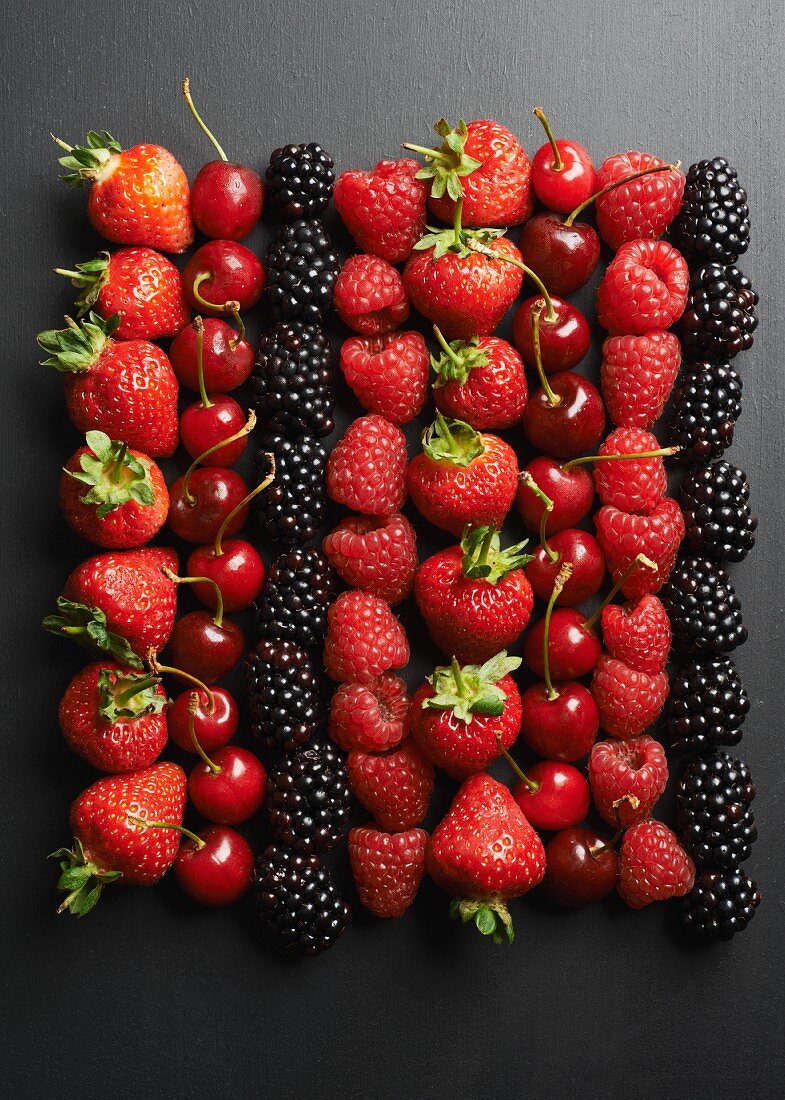 Summer fruits on a black surface