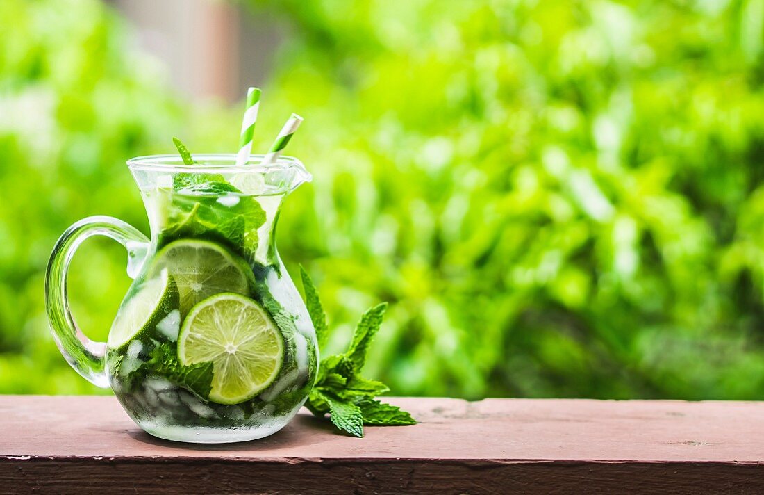 A jug of mojito on a garden table