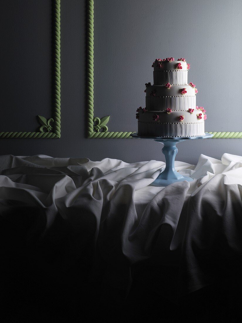 A three-tiered wedding cake on a cake stand