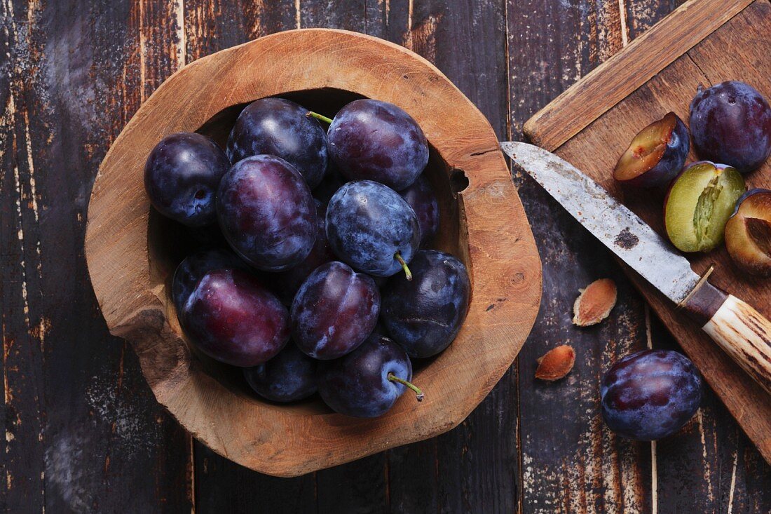 Fresh plums in a wooden bowl