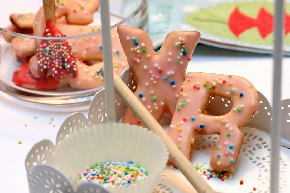 Letter shaped Christmas biscuits decorated with sugar sprinkles