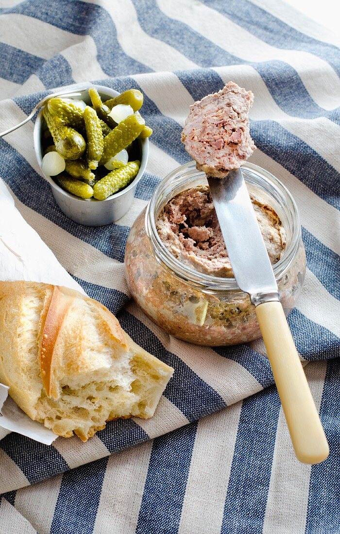A jar of Breton Pate de campagne with cornichons and baguette