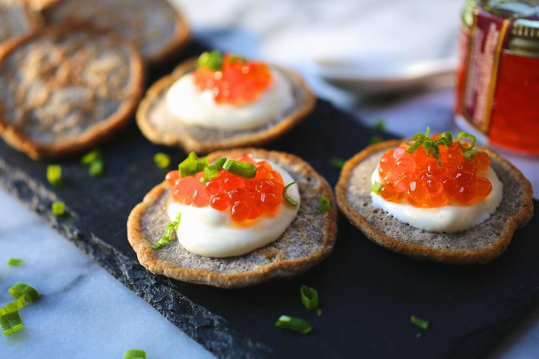 Blinis with sour cream and salmon caviar