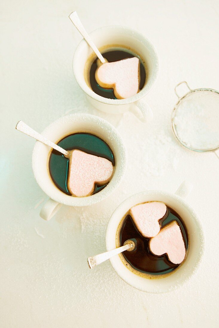 Cups of coffee with marshmallow hearts