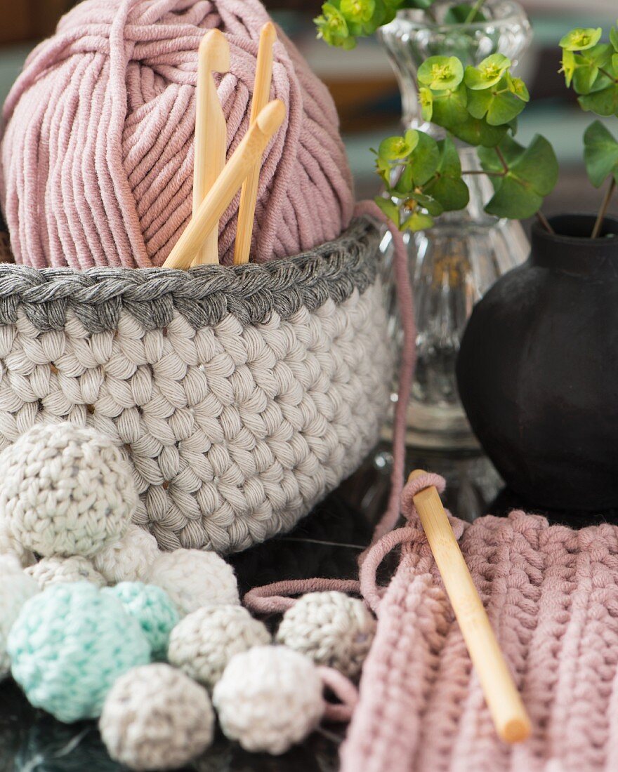 Crocheted basket with a ball of wall and small crocheted balls