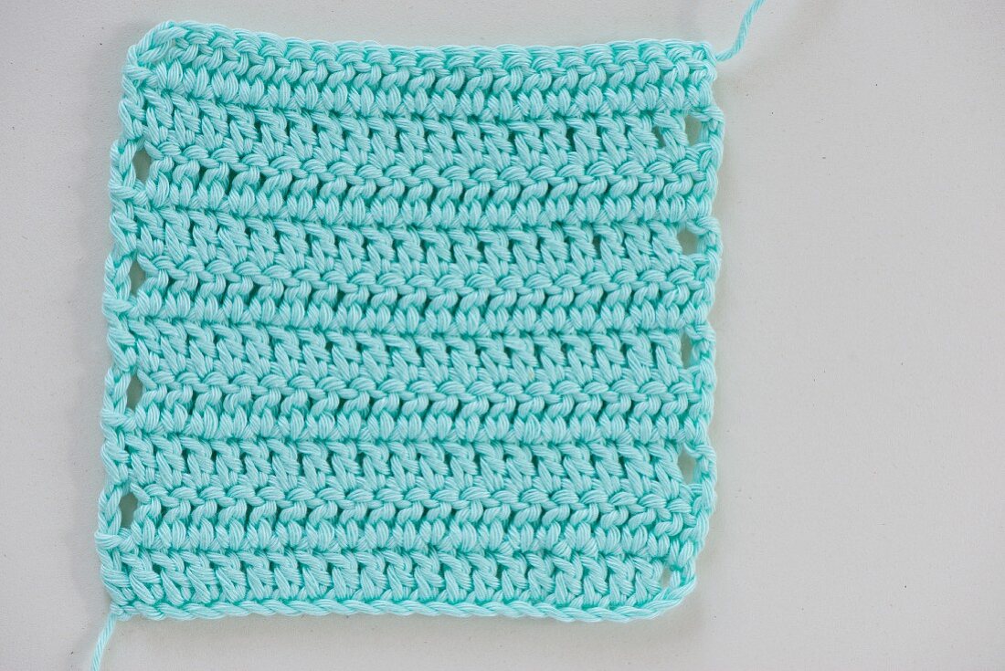 A crocheted gauge: rows of double crochet