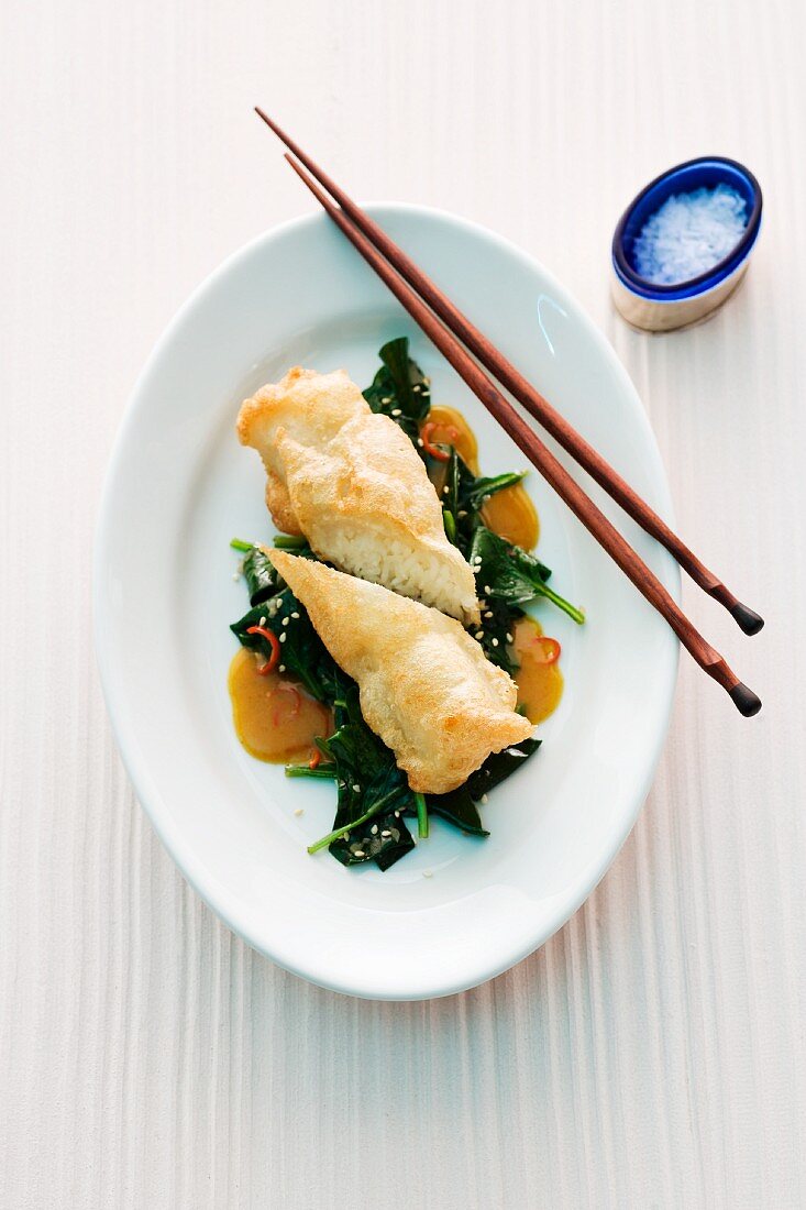 Fried rice rolls on leafy greens (Asia)