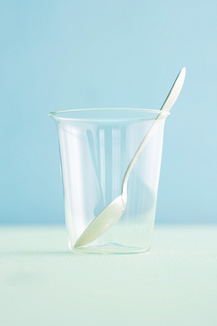 An empty cup with a spoon