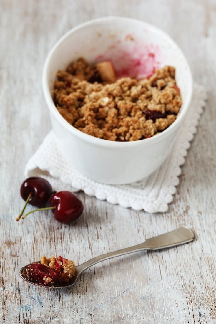 A bowl of apple and cherry crumble