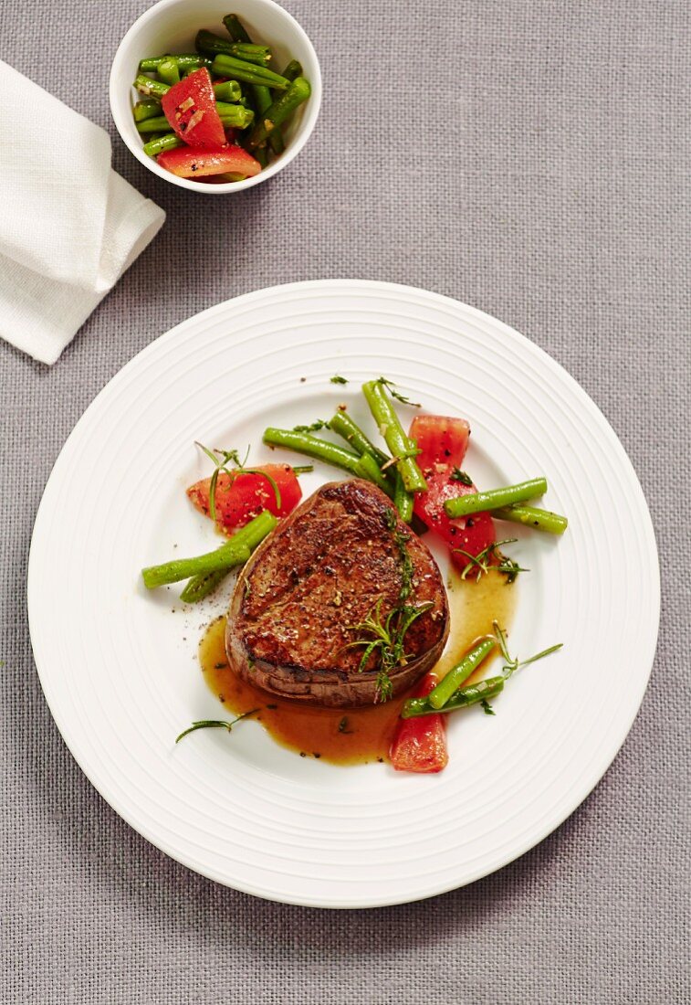 Bison fillet steak with a bean and tomato medley