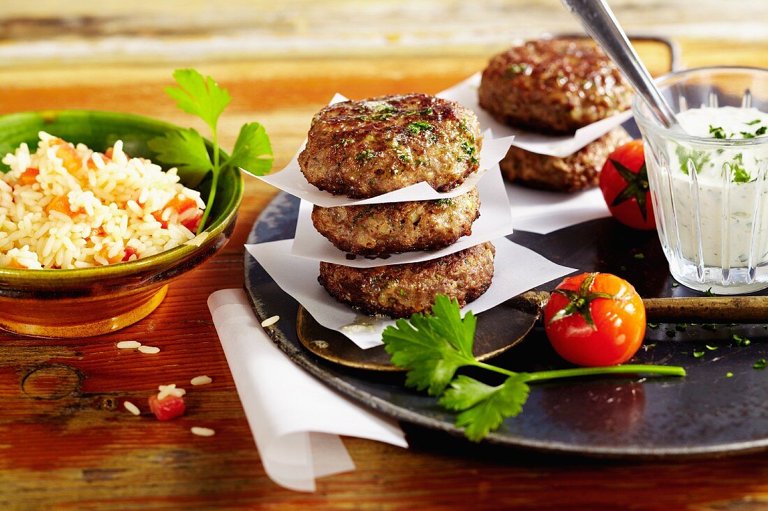Bulgarian lamb burgers with pilau rice and a sheep's cheese sauce