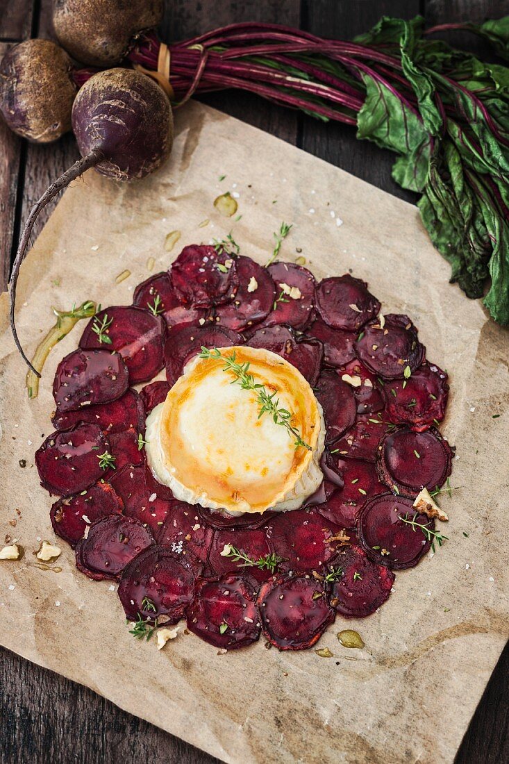 Beetroot carpaccio with goat's cheese on a piece of baking paper