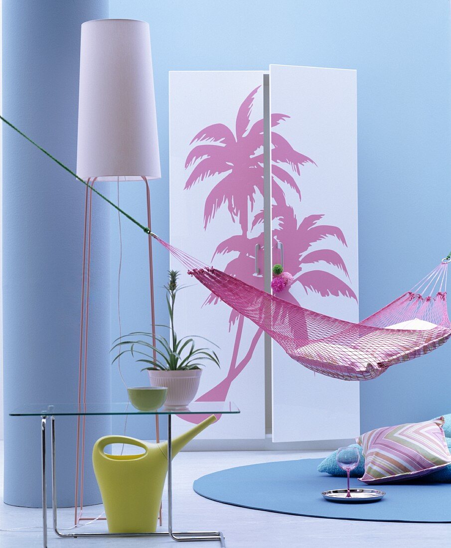 Hammock, standard lamp and wardrobe with palm-tree motifs on front