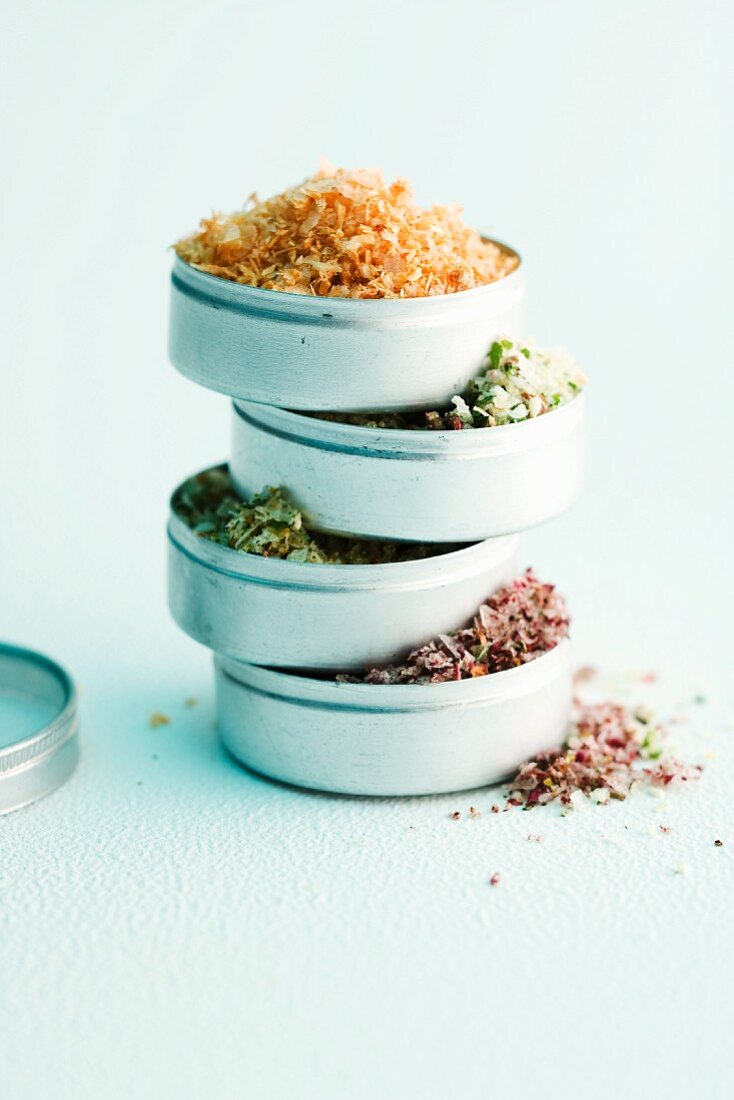Various types of spiced salt in dishes (stacked)