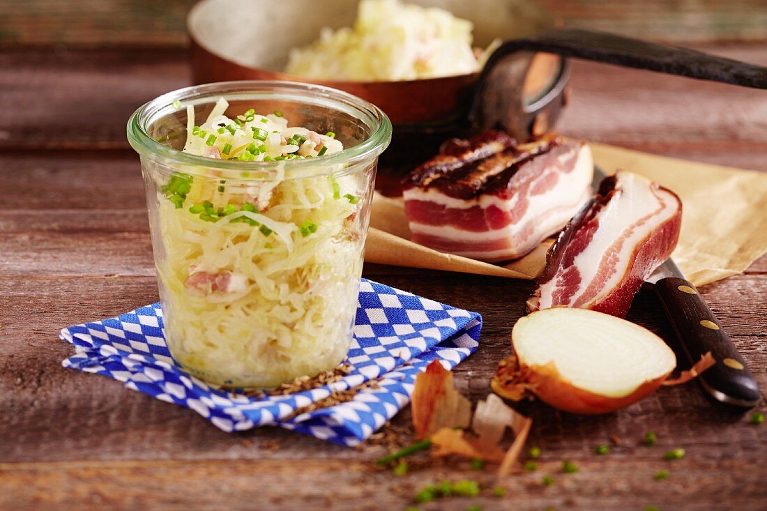 A jar Bavarian coleslaw with onions and bacon