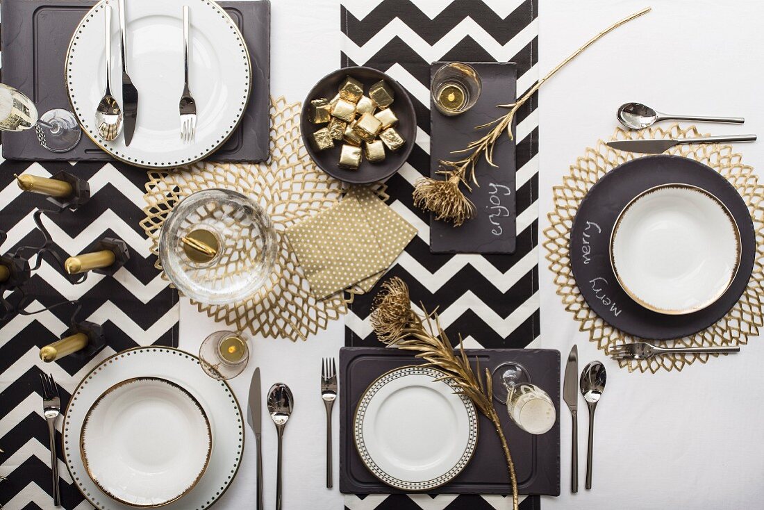 Festively set table in black, white and gold (top view)