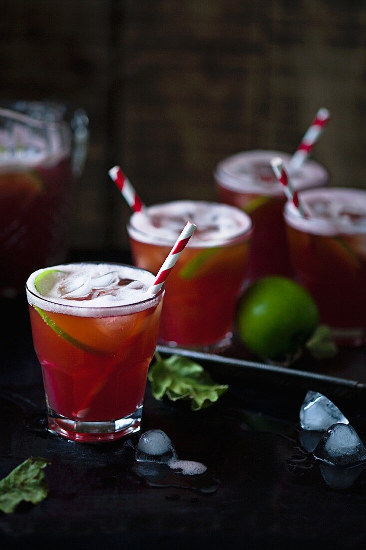 A cocktail with vodka, limes, cranberry and apple juice