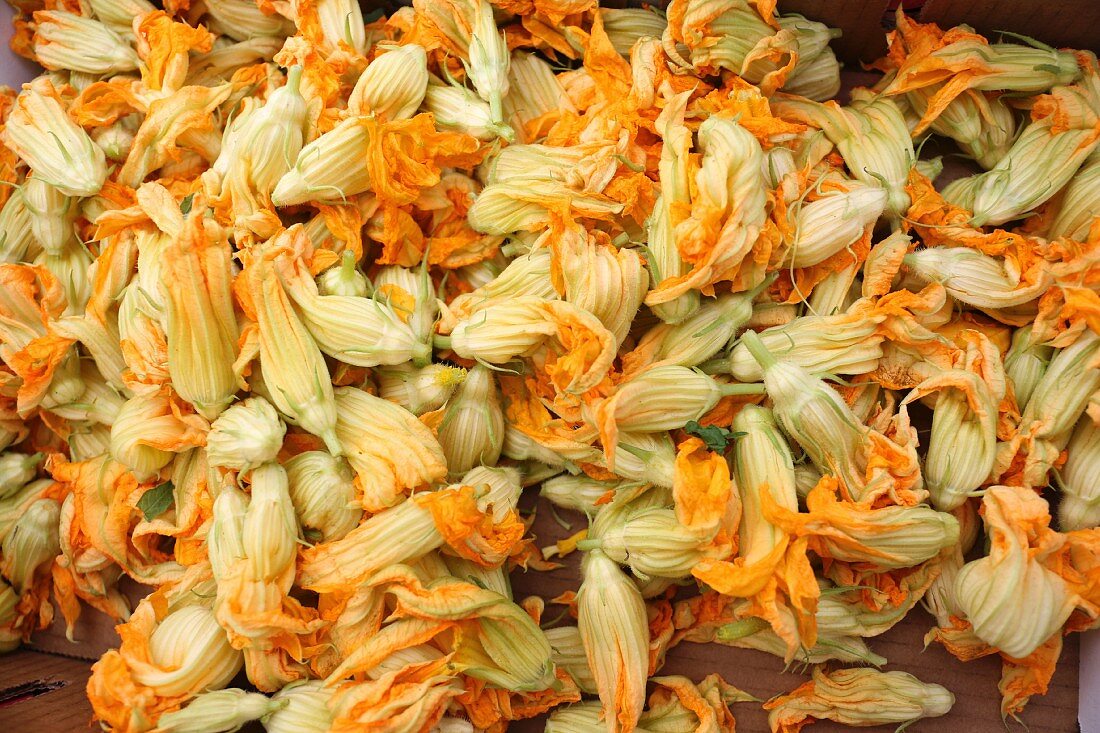 Courgette flowers in a box at a market