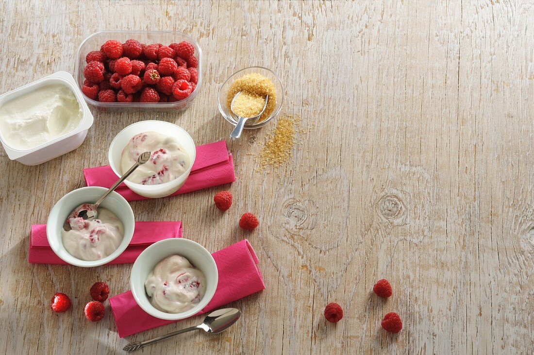 Raspberry quark with ingredients on a wooden surface