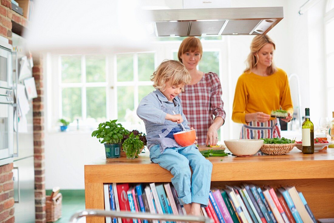 A mother and children cooking in a kitchen