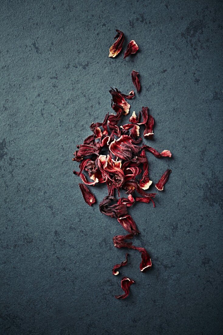 Dried hibiscus flowers on a stone surface