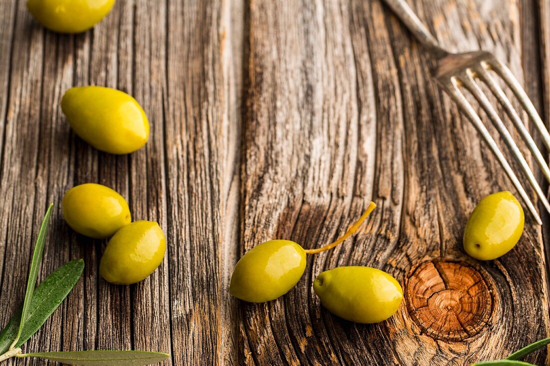 Fresh olives on a wooden surface