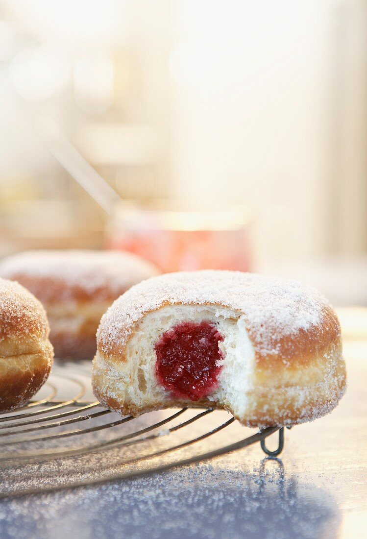 Jam doughnuts on a wire rack