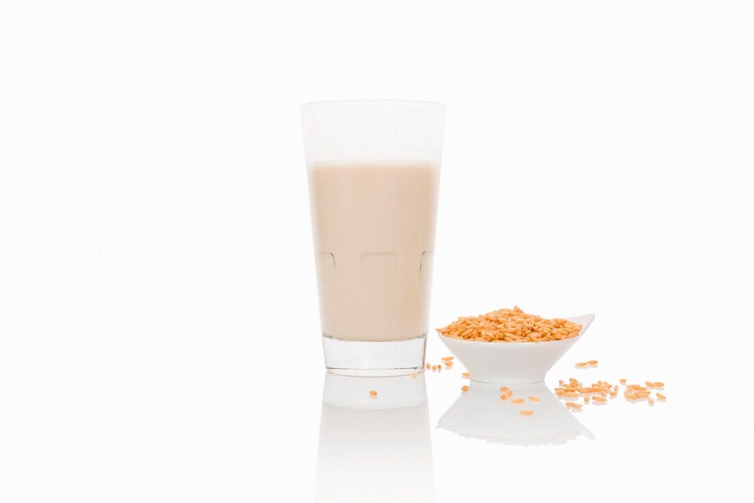 A glass of grain milk on a white surface