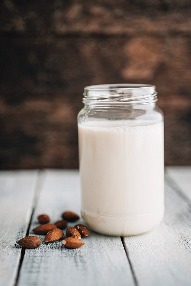 A jar of almond milk with almonds