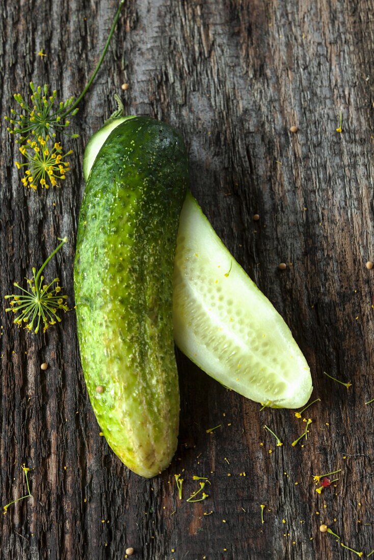 A halved gherkin on a wooden surface