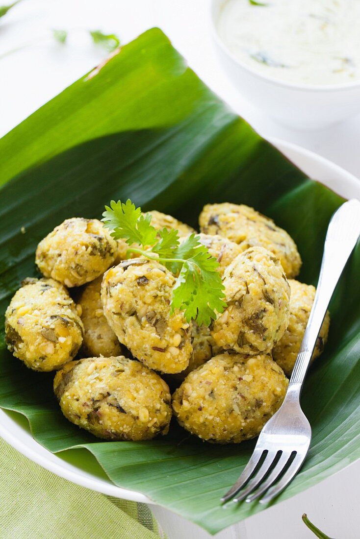 Steamed lentil balls on a banana leaf