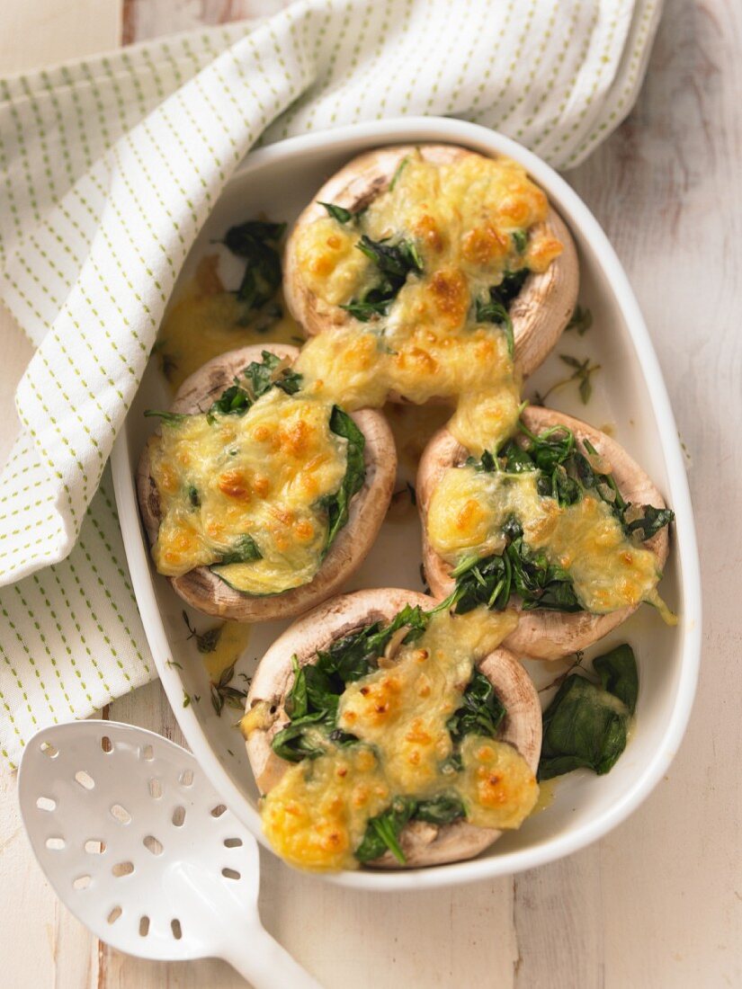 Gratinated mushrooms filled with spinach and cheese