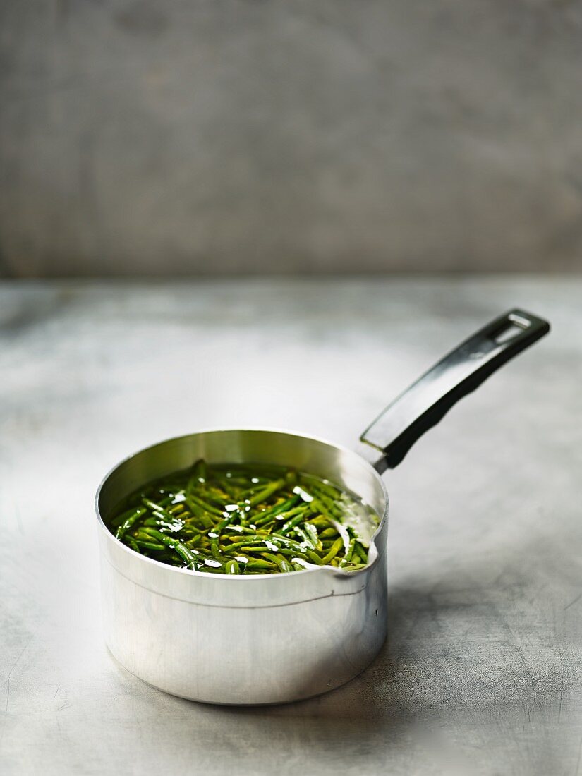 Samphire in oil in a saucepan