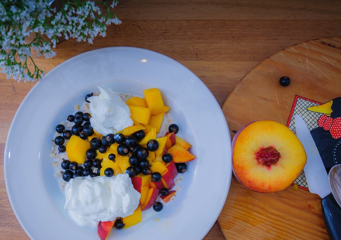 Muesli made from peaches, mango, redcurrants, quark, milk and oats