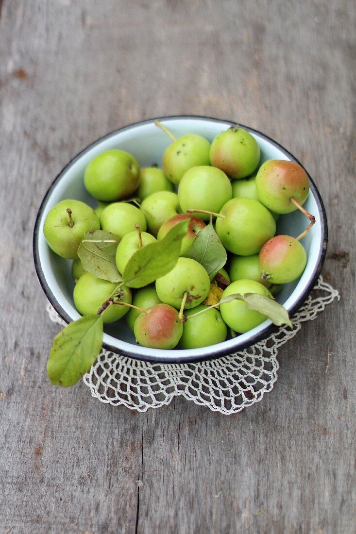A bowl of little green apples