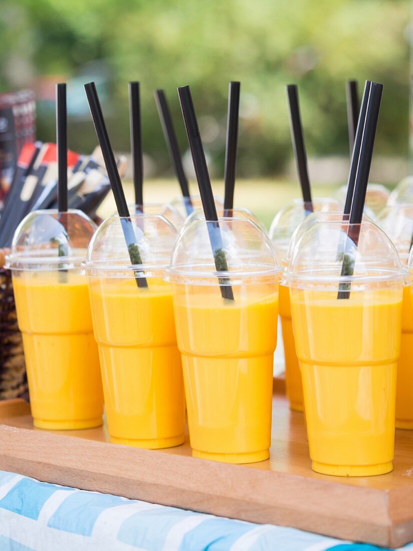 Mango lassis in take away plastic cups sold on a market stall