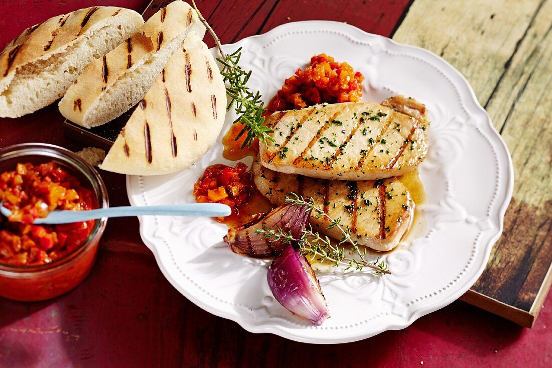 Grilled pork loin with pepper relish and pita bread