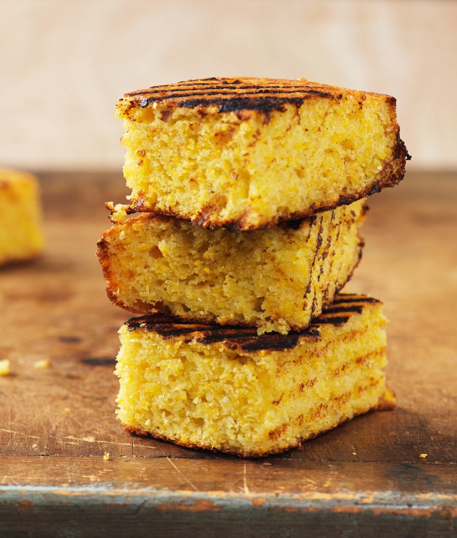 A stack of three slices of grilled cornbread