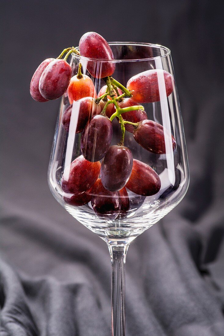 Red grapes in a wine glass