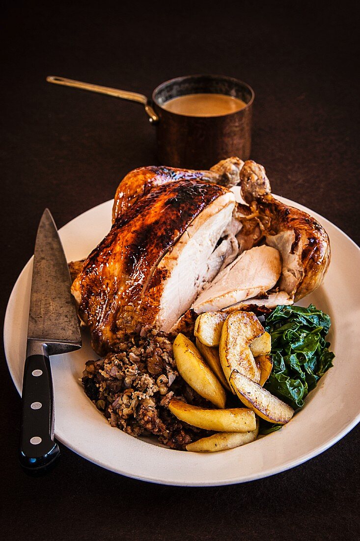 Roast chicken with stuffing, spinach, gravy and baked apples