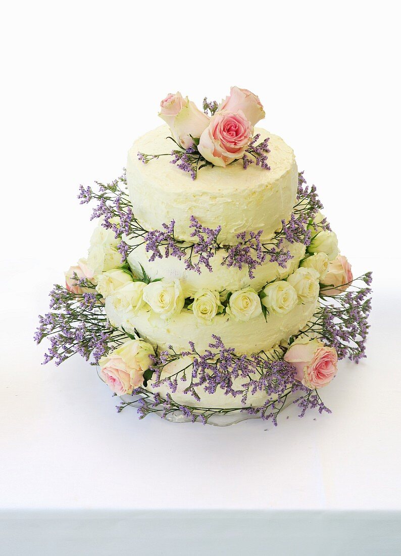 A four-tier wedding cake decorated with roses