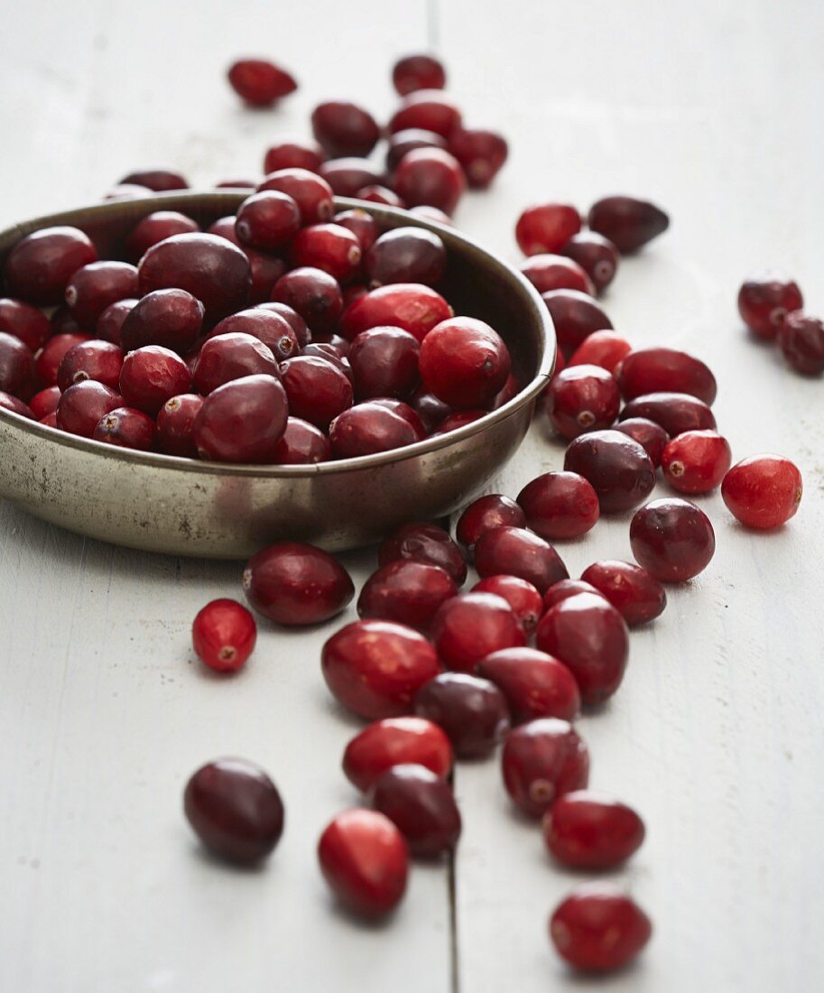 Lingonberries in a metal bowl and next to it