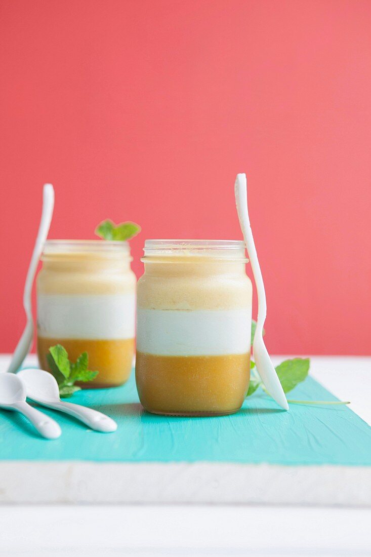 A layered dessert with mango, coconut and pineapple cream