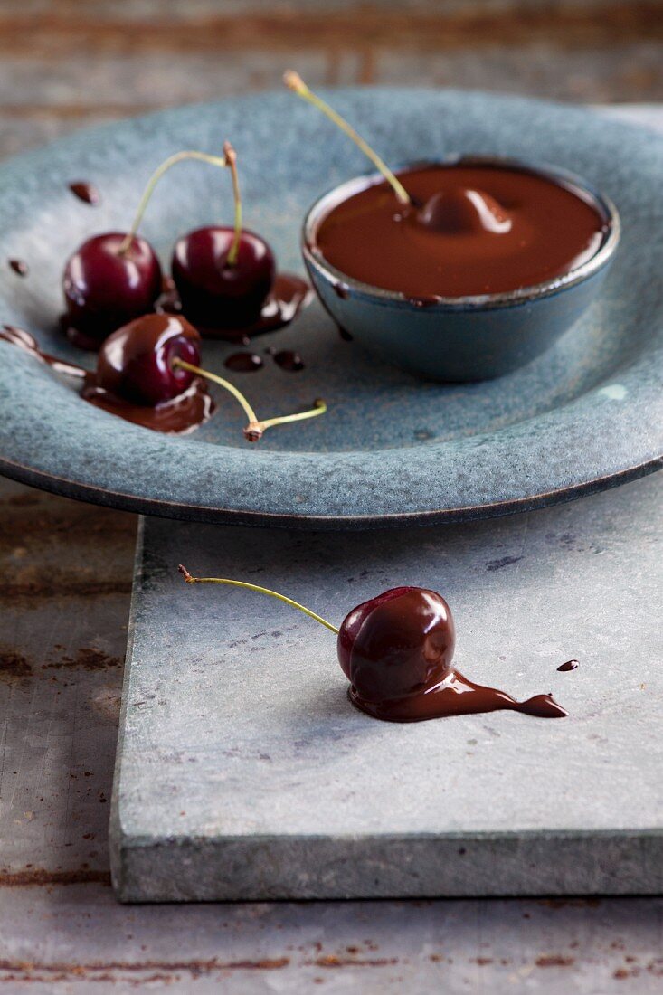 Cherries being dipped into chocolate