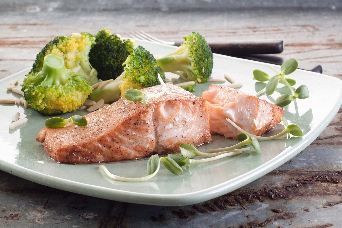 Salmon fillet with broccoli florets and sunflower shoots