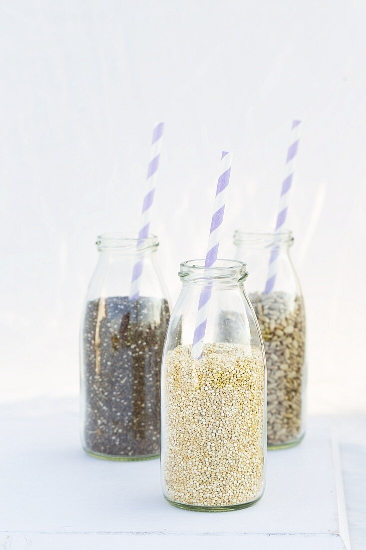 Chia, sunflower seeds and quinoa in milk bottles