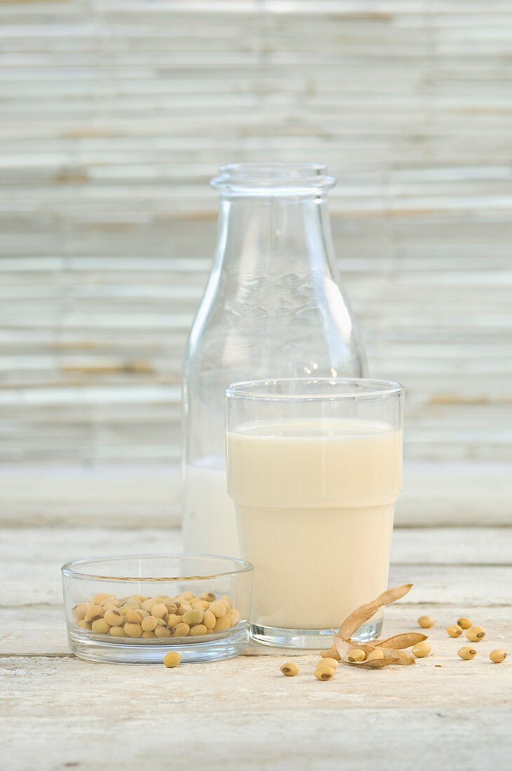 Soya milk in a glass and a bottle